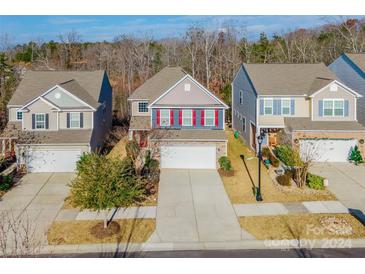 Three-story houses with two-car garages and front yards at 1270 Hideaway Gulch Dr, Fort Mill, SC 29715