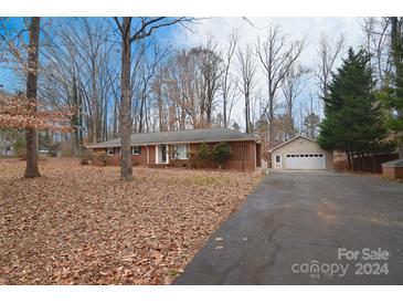 Brick ranch house with attached garage and large yard at 16523 Clear Creek Dr, Midland, NC 28107