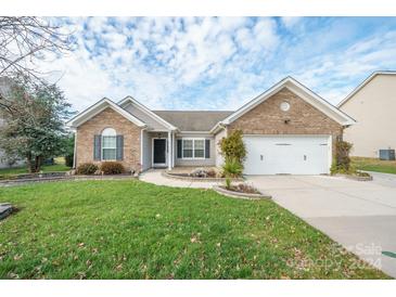 Brick ranch home with 2-car garage, landscaping, and a spacious lawn at 5315 Hackberry Sw Ln, Concord, NC 28027