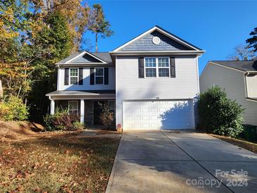 Two-story house with gray siding, a two-car garage, and a landscaped yard at 7917 E Lane Dr # 64, Charlotte, NC 28212