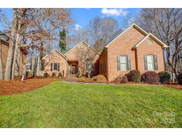 Brick home with landscaped lawn and mature trees at 952 Hummingbird Ln, Rock Hill, SC 29732