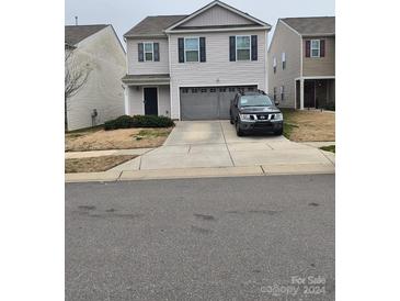 Two-story house with gray siding, two-car garage, and driveway at 3173 Green Apple Dr, Dallas, NC 28034