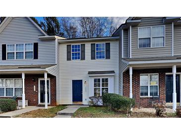 Inviting exterior of charming townhome, featuring a brick and siding facade at 7841 Petrea Ln, Charlotte, NC 28227