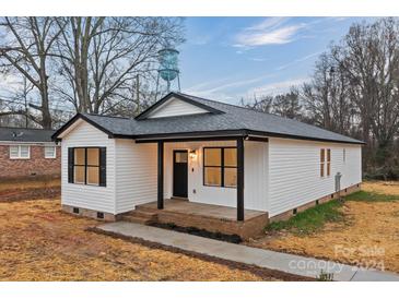 White house with black accents and a covered porch at 305 Washington St # 1, York, SC 29745