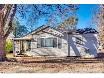 Tan house with screened porch and mature trees in the front yard at 1337 Eisenhower Rd, Rock Hill, SC 29730