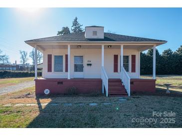 Charming one-story house with a front porch and well-maintained lawn at 504 Mclean Ave, Belmont, NC 28012