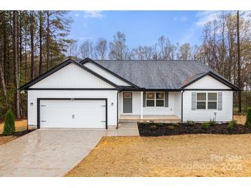 White house with gray roof, two-car garage, and landscaped yard at 2177 Mintew Cir, Lincolnton, NC 28092