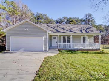 Newly constructed home with a gray exterior, white garage door, and a covered porch at 356 Cooper Farm Rd, Statesville, NC 28625