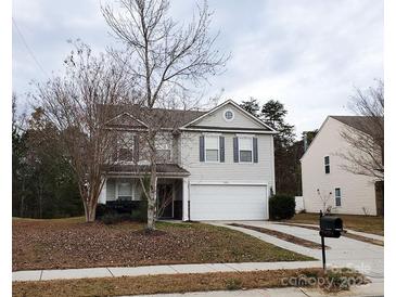 Two-story house with gray siding, a two-car garage, and a landscaped lawn at 13926 Lawrence Farm Ln # L49, Charlotte, NC 28278