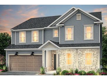 Two-story house featuring gray siding, stone accents, and a two-car garage at 5157 Hales Ford Rd # 22, Charlotte, NC 28215