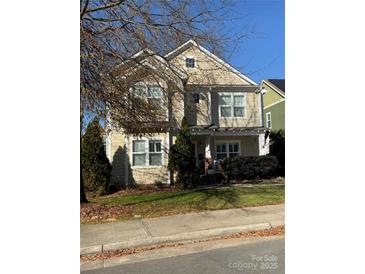 Tan two-story house with white trim and landscaping at 624 Waco St, Charlotte, NC 28204