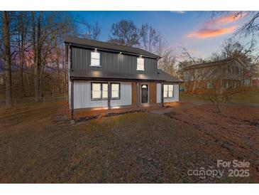 Stylish two-story home with modern exterior and landscaping at 5400 Larewood Dr, Charlotte, NC 28215