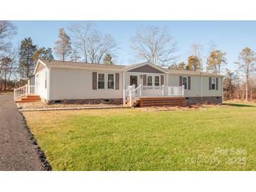 Ranch style home with landscaping and driveway at 816 Perry Rd, Troutman, NC 28166