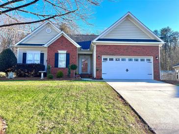 Brick ranch home with attached two-car garage and well-maintained lawn at 3143 River Ridge Dr, Gastonia, NC 28056