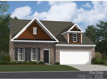 Brick front exterior of charming one-story home with two-car garage at 1984 Copper Path Dr, Fort Mill, SC 29715