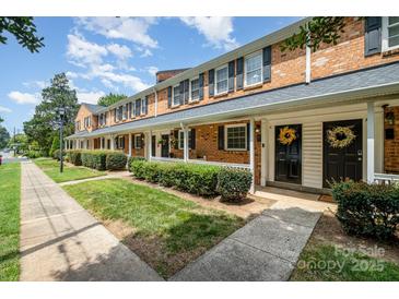 Brick townhouses with front porches and landscaping at 1210 Green Oaks Ln # G, Charlotte, NC 28205