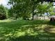 Spacious backyard with lush green grass and mature trees at 507 North Dr, Cherryville, NC 28021