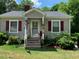 Cozy cottage with gray siding, red shutters, and a welcoming front porch at 507 North Dr, Cherryville, NC 28021