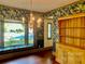 Dining room with floral wallpaper, wood floors, and built-in hutch at 298 Shadowbrooke Ln, Mooresville, NC 28117