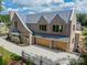 Brick home with three-car garage and a metal roof at 8010 Litaker Manor Ct, Charlotte, NC 28270