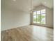 Spacious bedroom with hardwood floors and large windows offering abundant natural light at 8010 Litaker Manor Ct, Charlotte, NC 28270