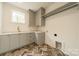 Modern laundry room with gray cabinets and herringbone patterned floor at 8010 Litaker Manor Ct, Charlotte, NC 28270