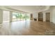 Open living room with hardwood floors, fireplace, and sliding glass doors at 8010 Litaker Manor Ct, Charlotte, NC 28270