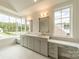 Elegant bathroom with double vanity, marble countertops, and a large window at 8010 Litaker Manor Ct, Charlotte, NC 28270
