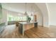 Modern kitchen with two islands, green cabinets, and marble countertops at 8010 Litaker Manor Ct, Charlotte, NC 28270
