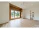 Bedroom with hardwood floors, large window, and wood wall accent at 8010 Litaker Manor Ct, Charlotte, NC 28270