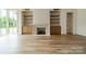 Living room with hardwood floors and a fireplace with built-in shelving at 8010 Litaker Manor Ct, Charlotte, NC 28270