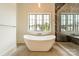 Luxurious bathroom with freestanding soaking tub and marble shower at 8010 Litaker Manor Ct, Charlotte, NC 28270