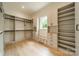 Large walk-in closet with custom built-ins and ample shelving at 8010 Litaker Manor Ct, Charlotte, NC 28270