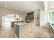 Open kitchen with two islands, green cabinets, and marble countertops at 8010 Litaker Manor Ct, Charlotte, NC 28270