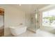 Luxurious bathroom featuring a freestanding tub and a glass-enclosed shower at 8010 Litaker Manor Ct, Charlotte, NC 28270