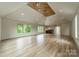 Spacious bonus room with hardwood floors, high ceilings, and wet bar at 8010 Litaker Manor Ct, Charlotte, NC 28270