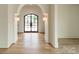 Bright and spacious entryway with hardwood floors and an arched doorway at 8010 Litaker Manor Ct, Charlotte, NC 28270