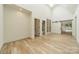 Bright hallway with hardwood floors, built-in shelving, and barn doors at 8010 Litaker Manor Ct, Charlotte, NC 28270