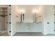 Double vanity with quartz countertop, custom cabinetry, and large mirrors at 8010 Litaker Manor Ct, Charlotte, NC 28270