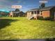 Two brick houses side-by-side with yards and ample parking at 835 & 837 Sikes Mill Rd, Monroe, NC 28110