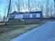 Two-story home with a blue exterior and driveway at 5756 Dalmatian St, Iron Station, NC 28080