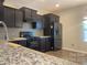 Modern kitchen with dark cabinets and granite countertops at 527 Smokehouse Ln, Albemarle, NC 28001