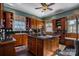 Spacious kitchen with island, wood cabinets, and granite countertops at 317 W Front St, Statesville, NC 28677