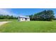 A small house on a grassy lot with tall trees nearby at 1672 Riverview Rd, Lincolnton, NC 28092