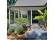Covered front porch with stone accents and lush landscaping at 3645 Lake Bluff Dr, Sherrills Ford, NC 28763