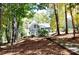 House nestled in woods with fall foliage at 3645 Lake Bluff Dr, Sherrills Ford, NC 28763