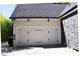 Attached garage with white doors and black accents at 3645 Lake Bluff Dr, Sherrills Ford, NC 28763