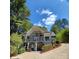 Two-story house with large windows, deck, and wooded setting at 3645 Lake Bluff Dr, Sherrills Ford, NC 28763