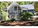 A-frame home with large windows and a deck overlooking wooded area at 3645 Lake Bluff Dr, Sherrills Ford, NC 28763