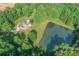 House, pool, and pond in wooded area at 1228 Brawley School Rd, Mooresville, NC 28117